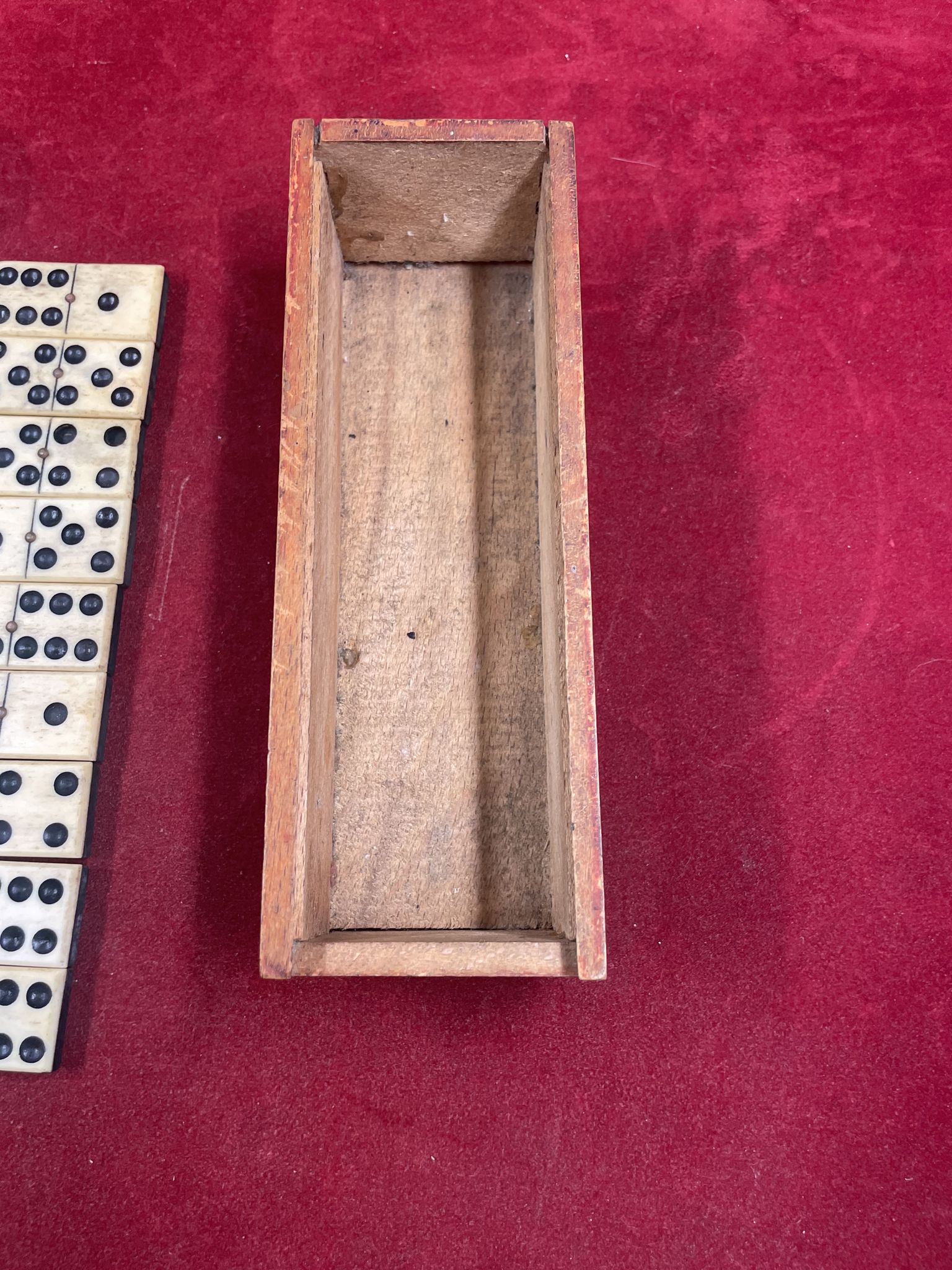 Set of complete dominoes made of bone, nails and blackened wood