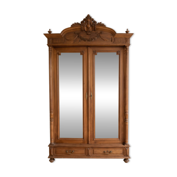 Antique solid wood wardrobe with mirror doors.
