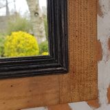 Black mirror and raw natural wood