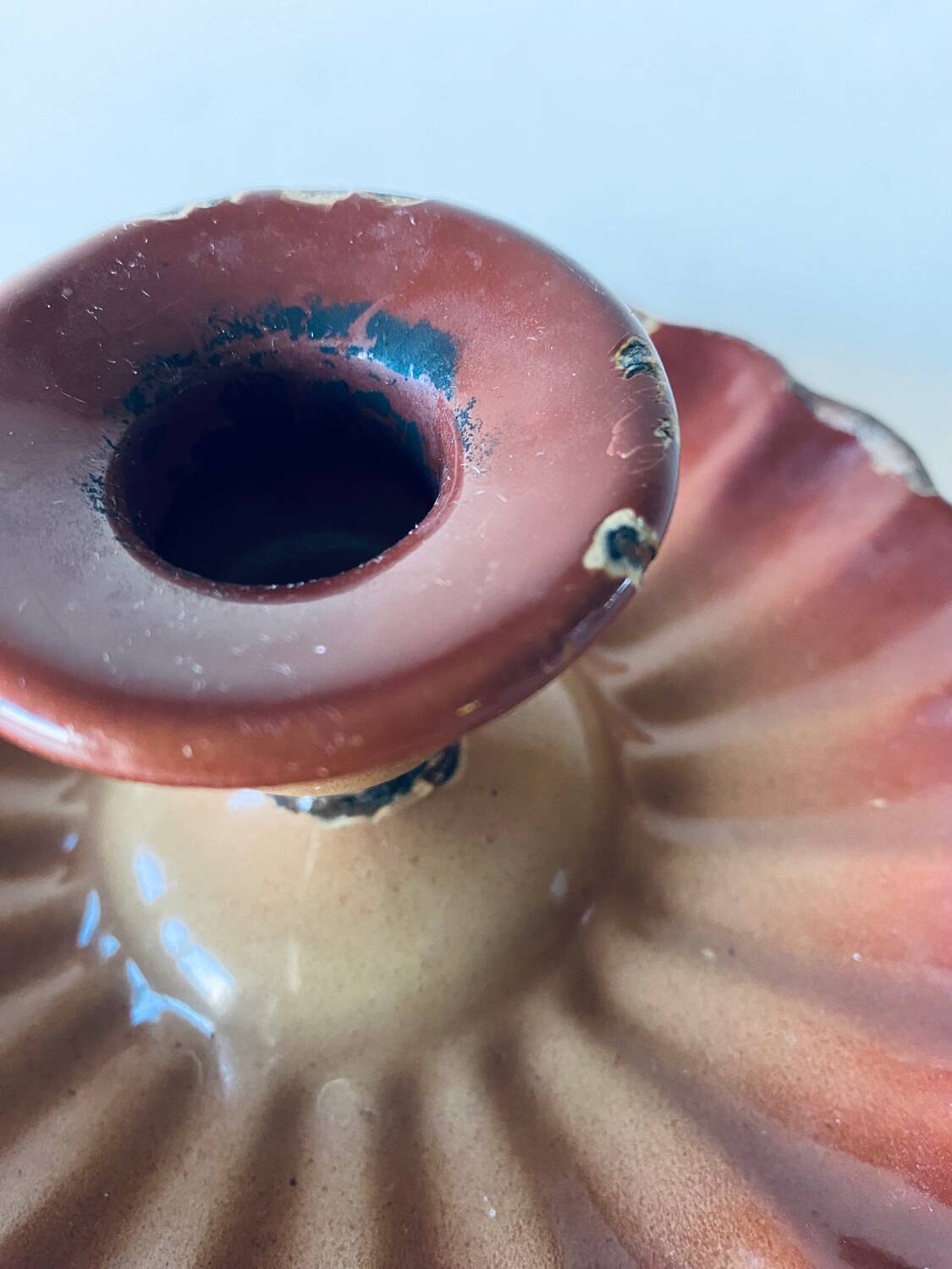 Old candle holder in brown enameled metal