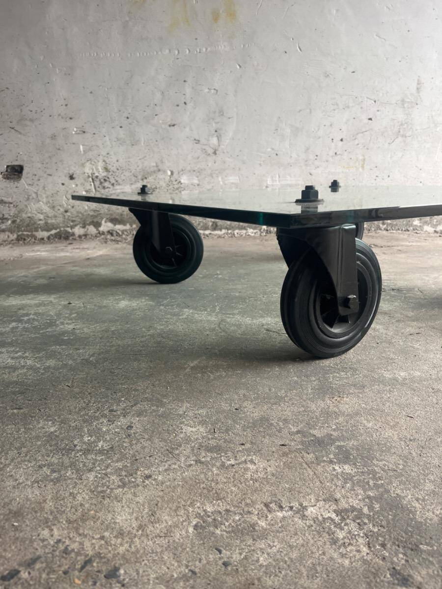 Gae Aulenti coffee table for Fontana Arte, transparent glass top with black cast iron supports, 1980s.