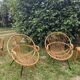 Paire de fauteuils coquille en rotin pieds acier