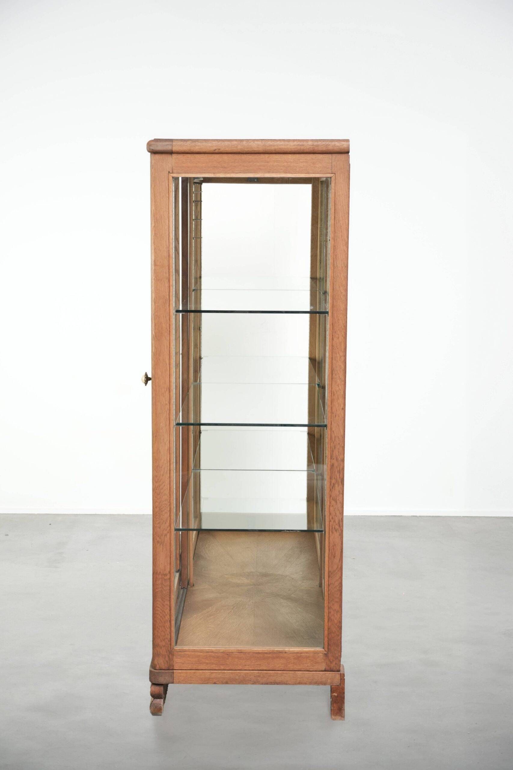 Antique Dutch oak display cabinet with glass shelves and a mirrored back