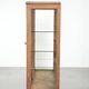 Antique Dutch oak display cabinet with glass shelves and a mirrored back