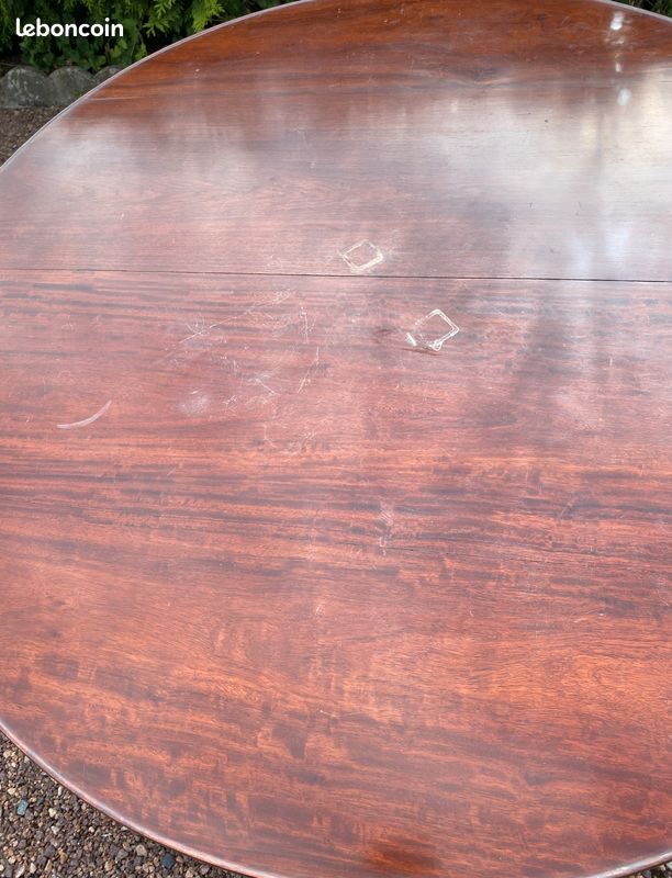 Old and large round winegrower's table made of wood.