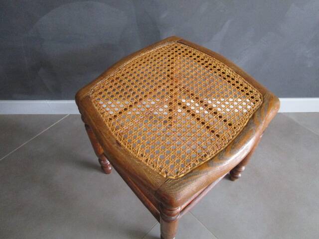 Antique wooden stool with cane seat.