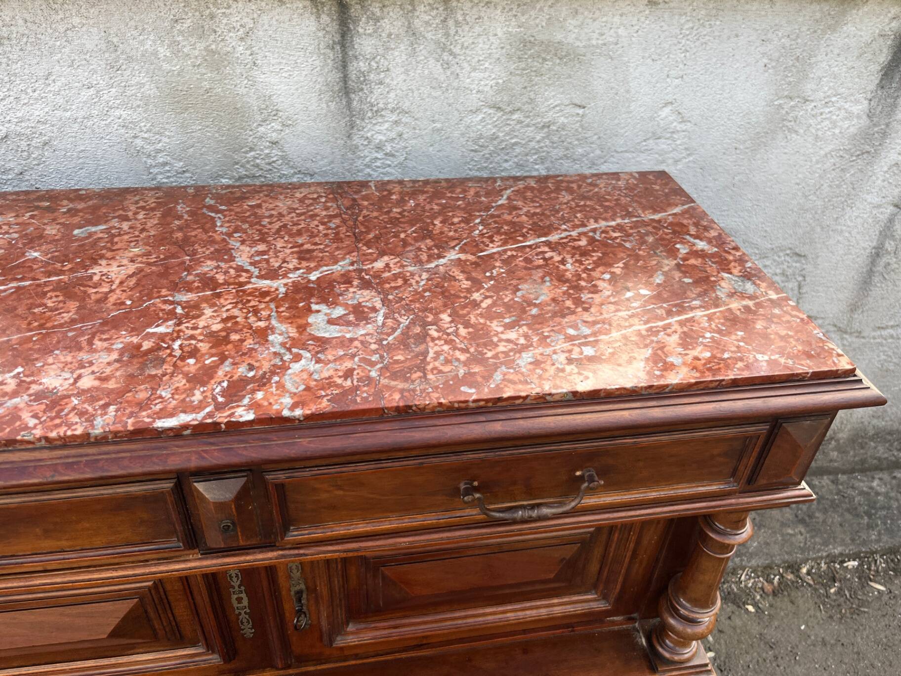 Henri II style console table with a red marble top.