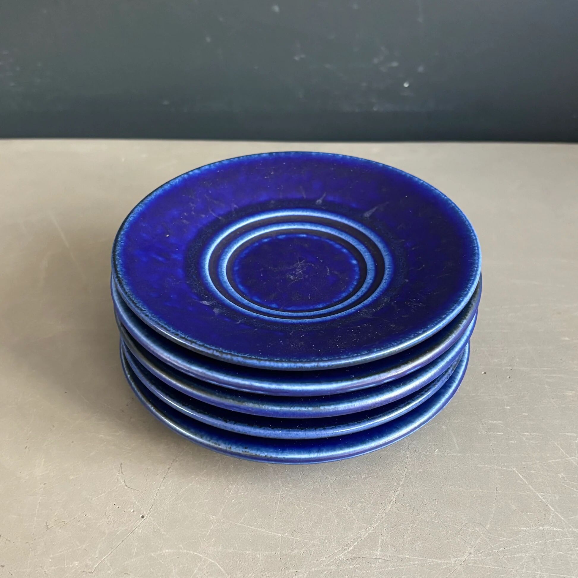 Set of 5 blue Klein ceramic tea cups with saucers.