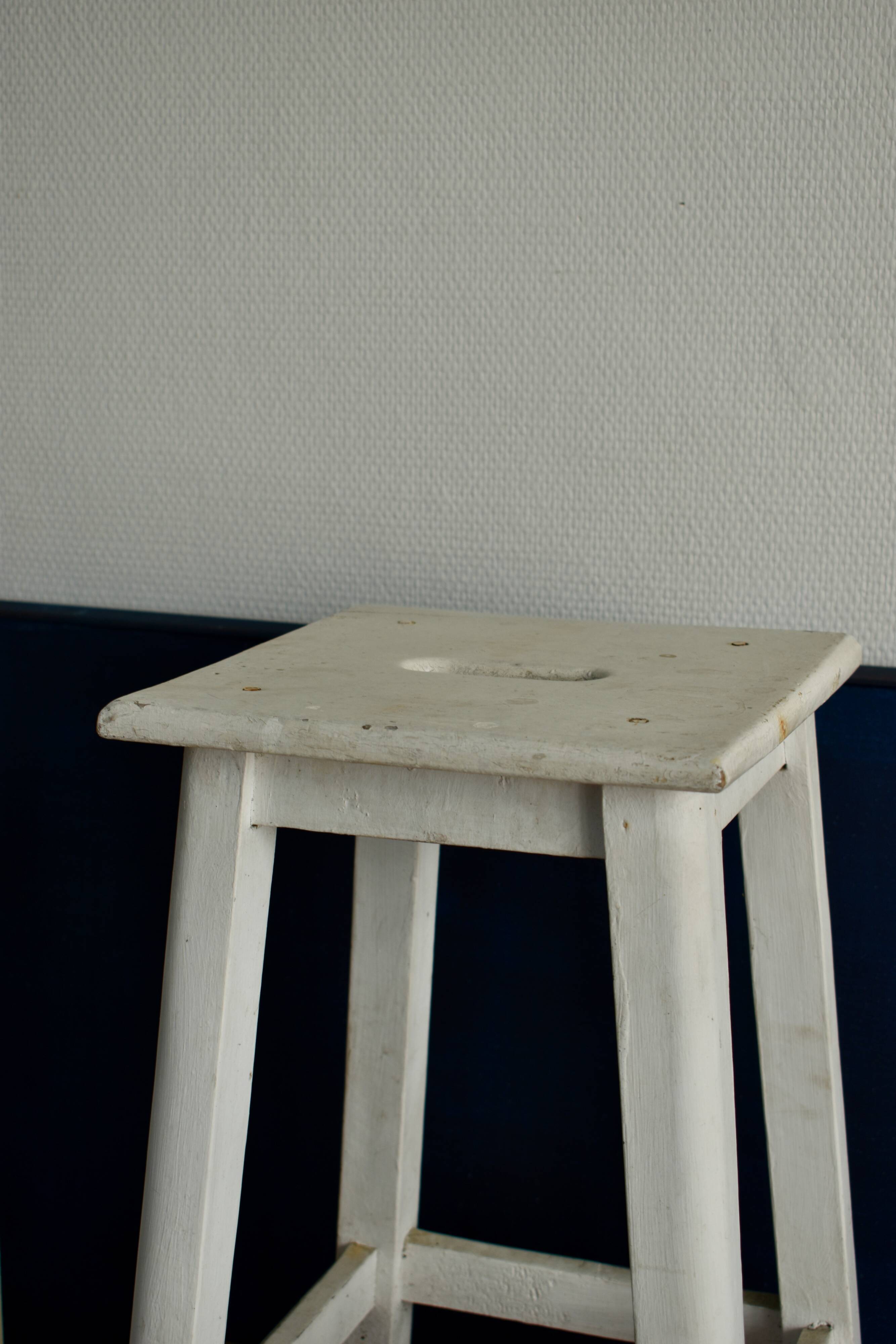 Old white wooden handle stool