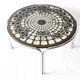 Black and white round coffee table with a mandala top and chrome metal base.