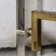 1970s dining table in travertine, gold metal and plexiglass.