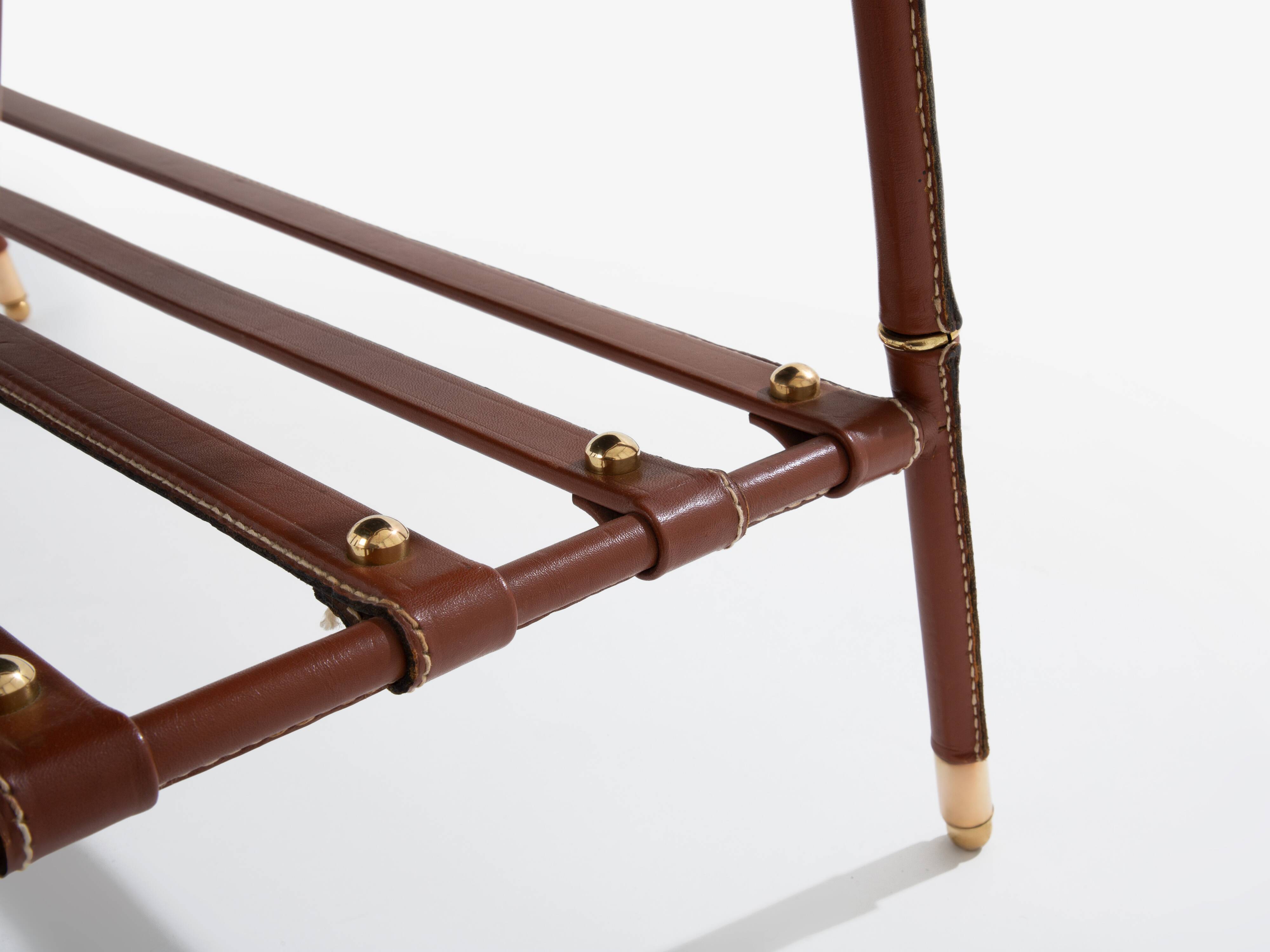 Jacques Adnet coffee table in red saddle-stitched leather and brass, 1950s