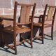Pair of oak armchairs with straw seats and backs.