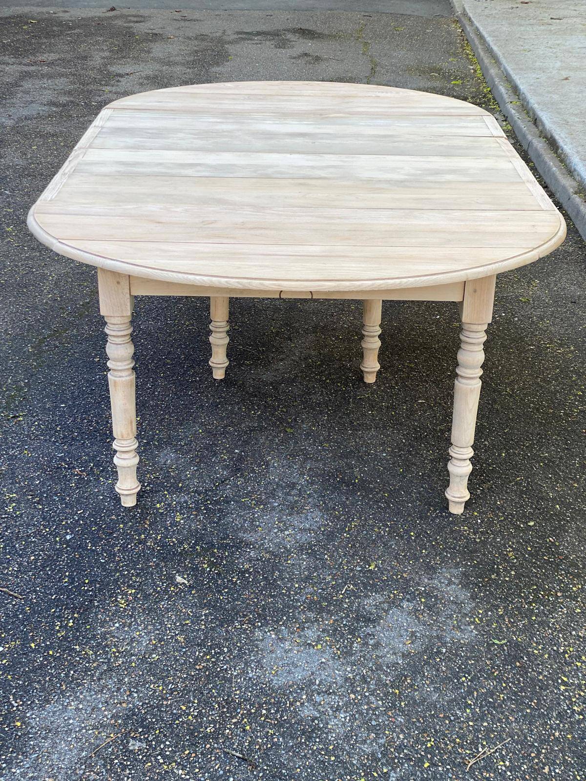 Renovated Louis Philippe round extendable dining table with 4 leaves.