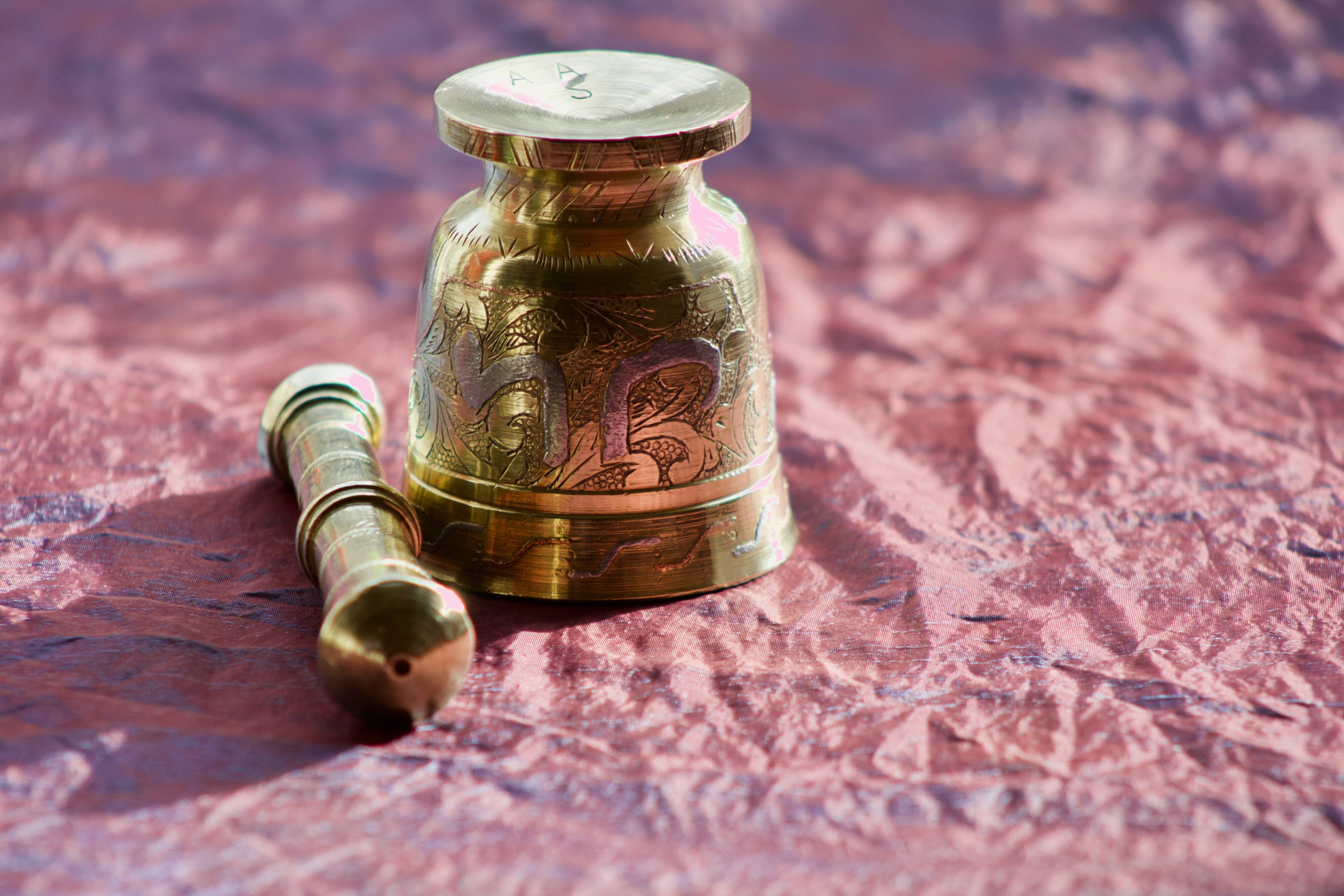 Mortar and its brass pestle with oriental gold and silver motifs