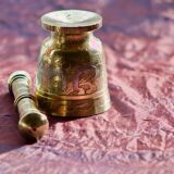 Mortar and its brass pestle with oriental gold and silver motifs