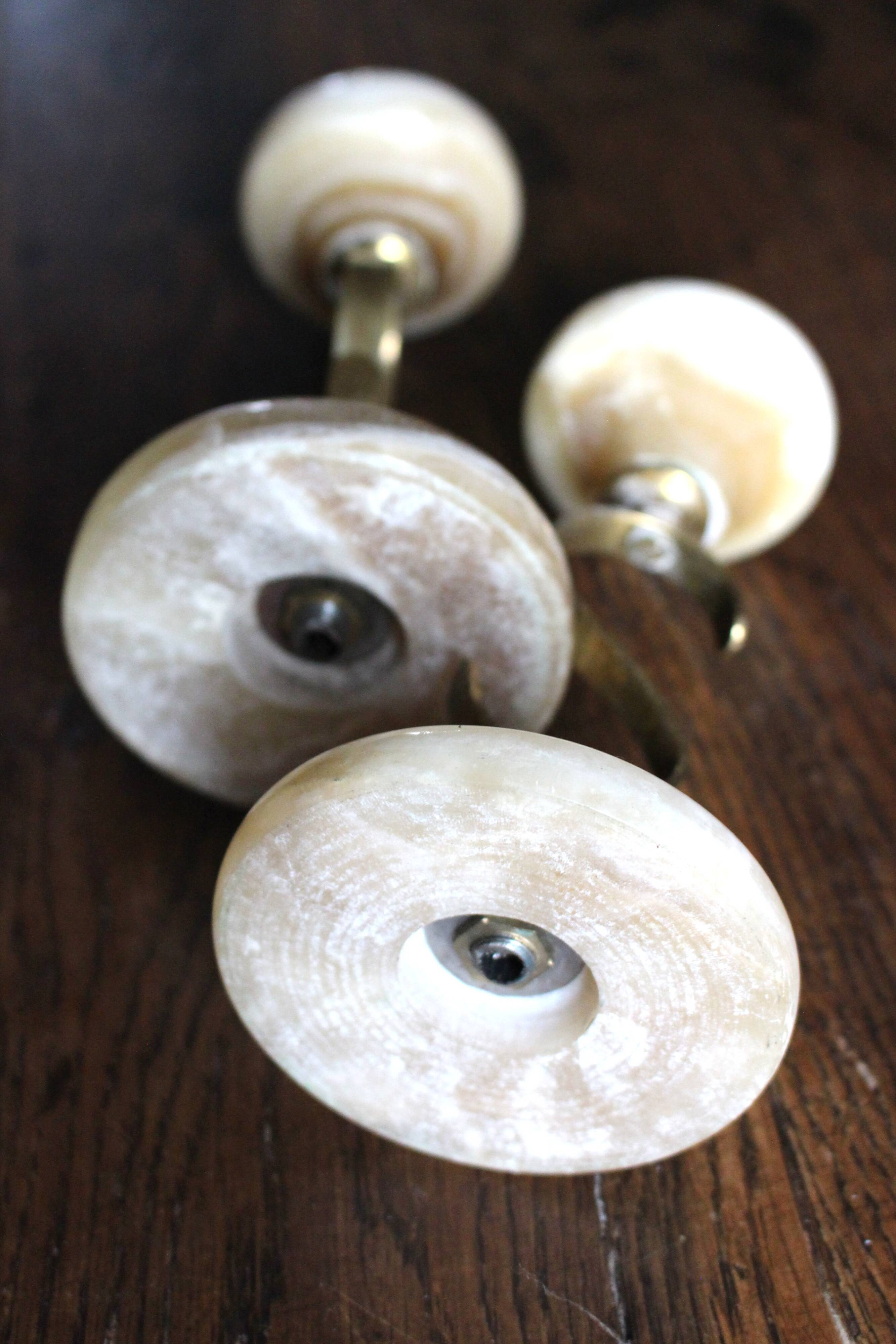 Pair of curved brass candlesticks with onyx