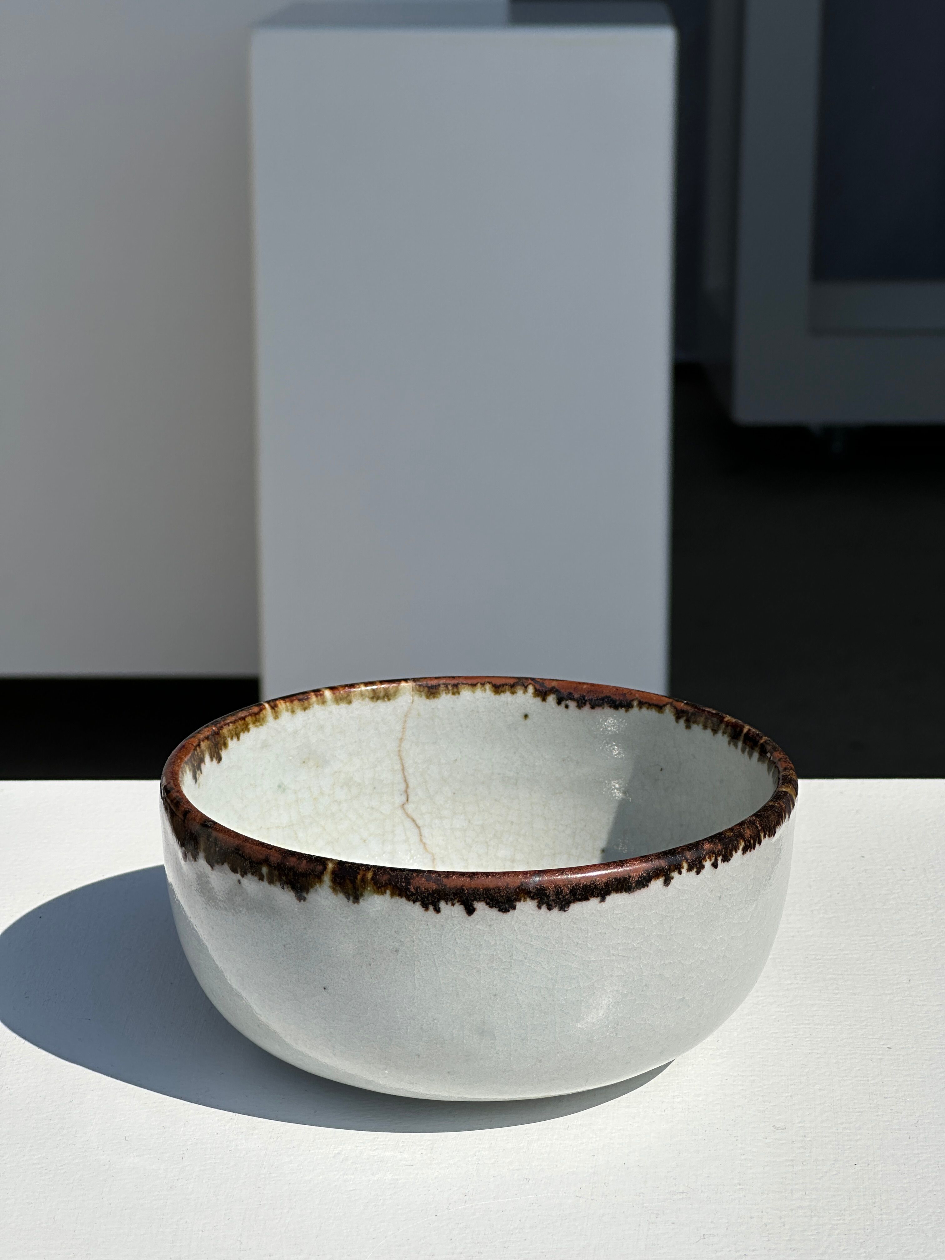 Small white glazed ceramic bowl black edges