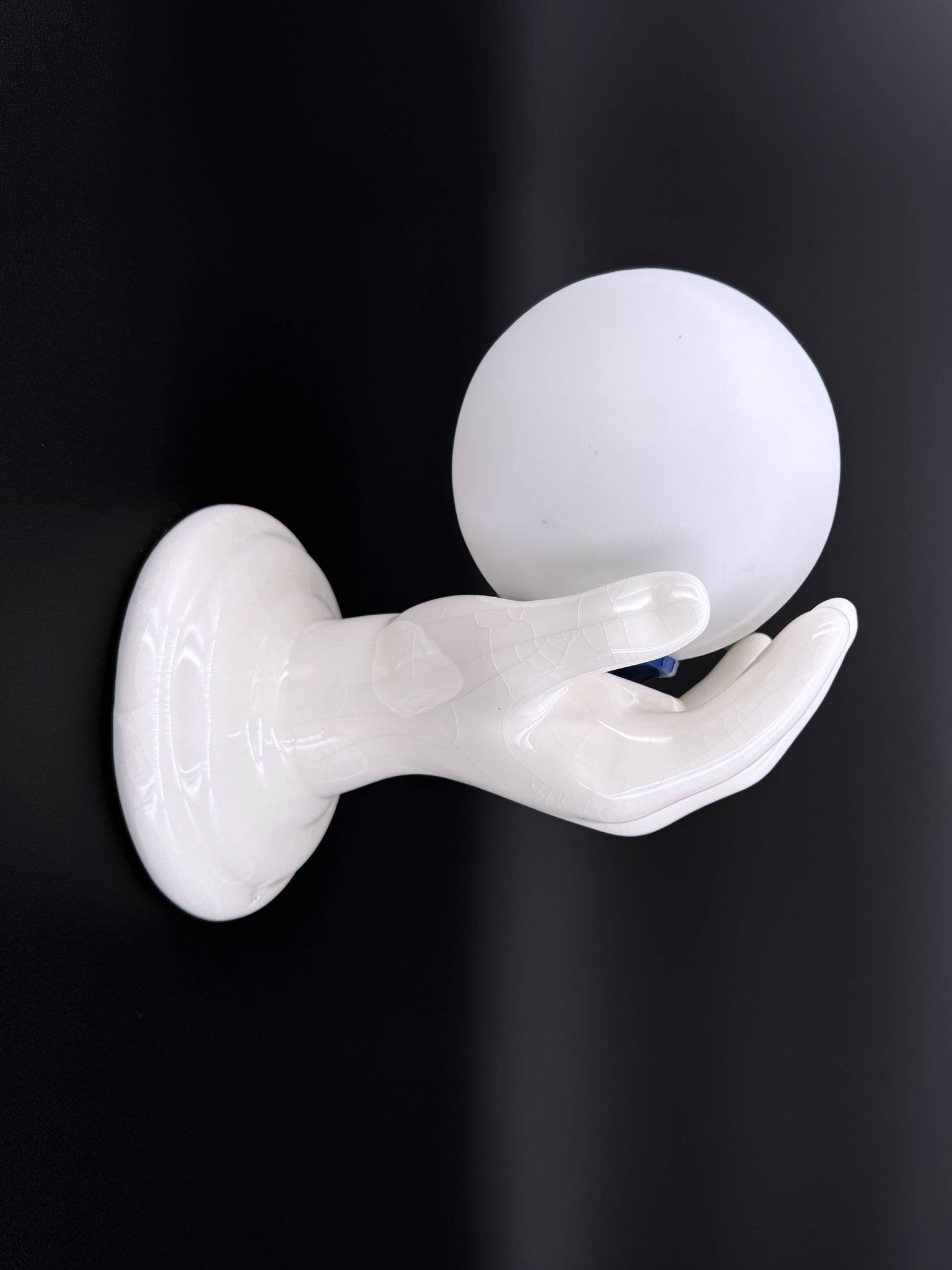 Vintage ceramic wall light - hand holding an opaline globe, 1970s