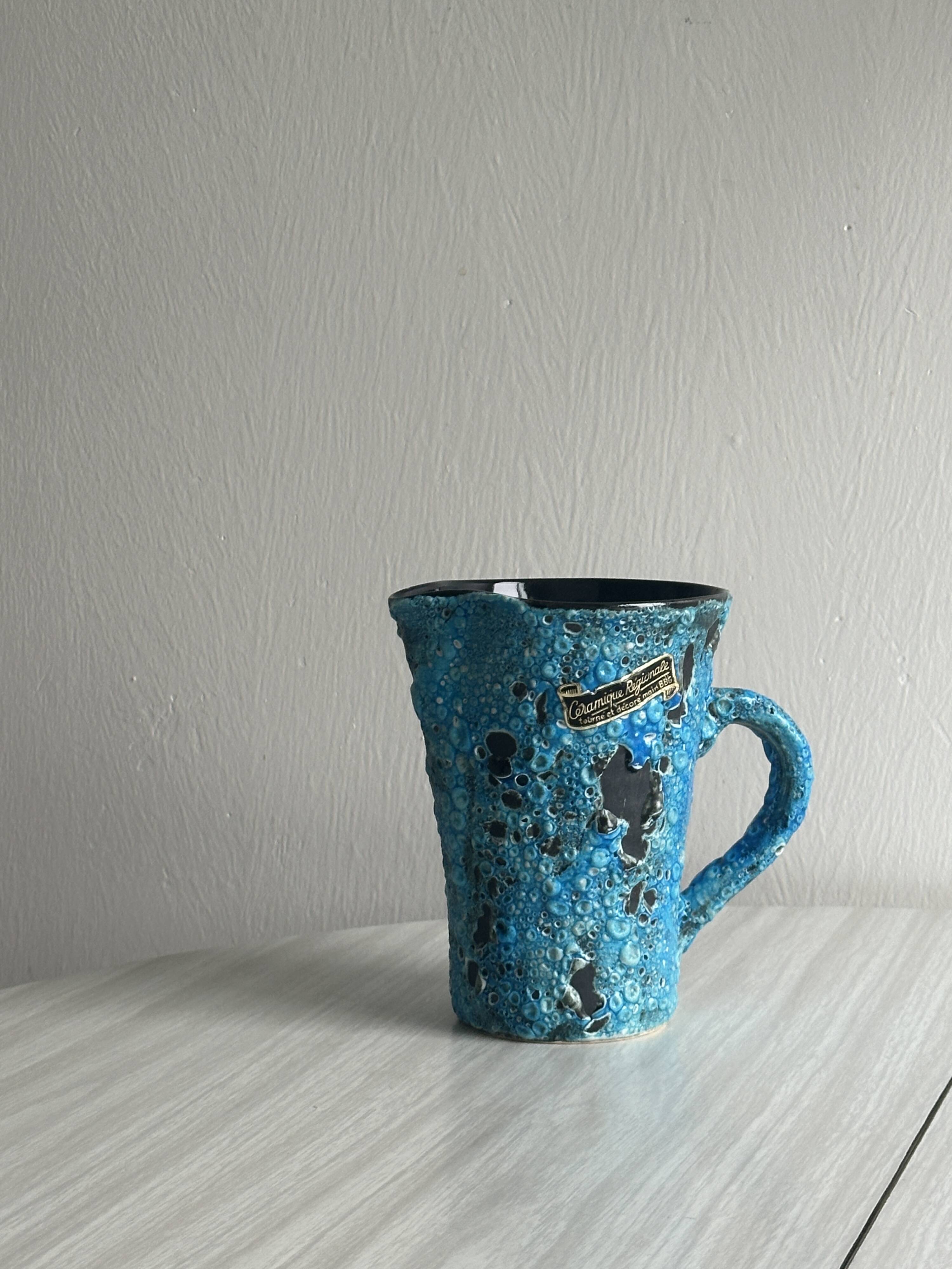Blue glazed ceramic pitcher