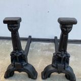 Pair of cast iron chenets with stylized faces High Epoch SEVENTEENTH century