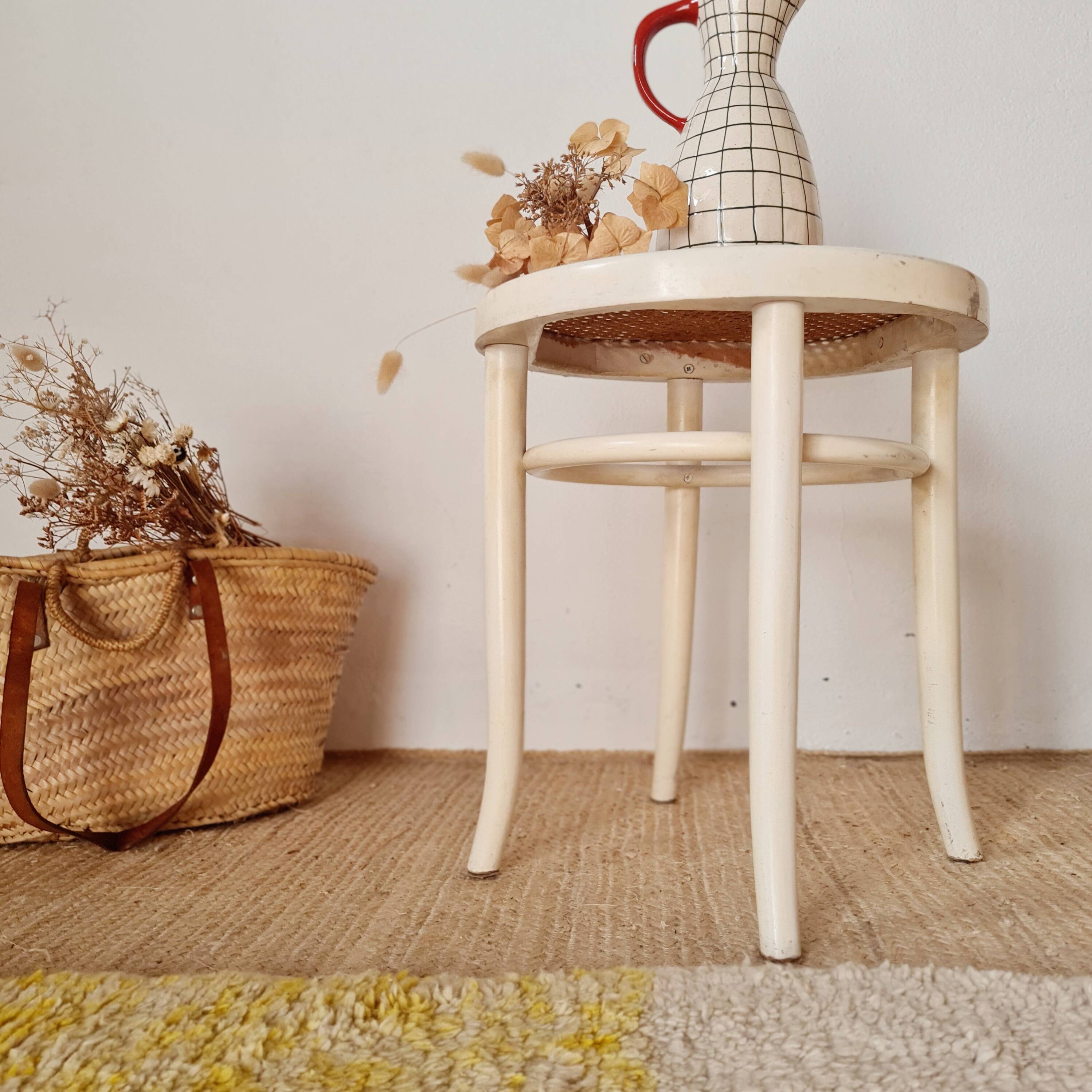 Antique stool with wood and cream caning.