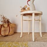 Antique stool with wood and cream caning.