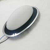 Oval wall lamp with mirror frame. 1980s 18x30cm