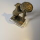 Brass sculpture, bear looking for honey in the tree