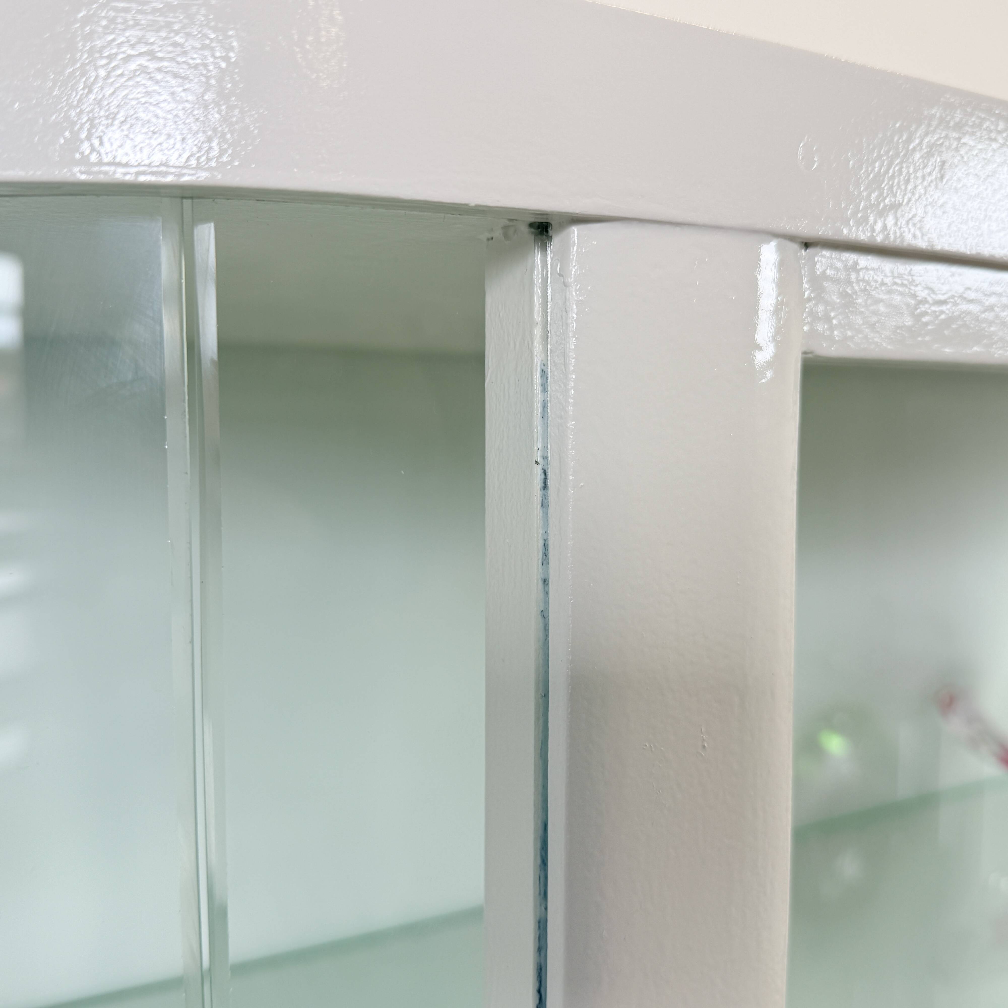 White vintage slatted display case on gold legs