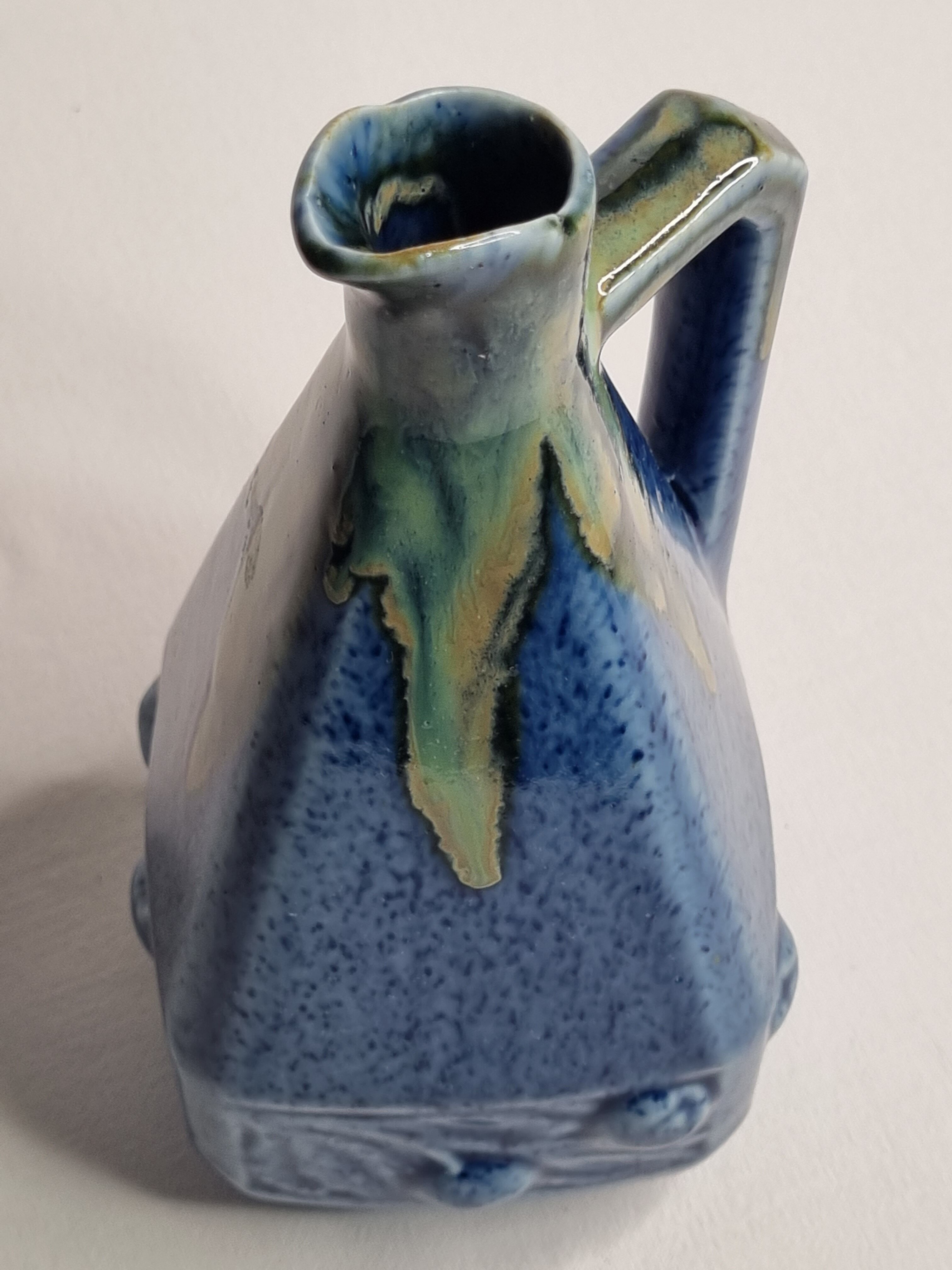 Art Deco pitcher in blue enamelled sandstone with fruit decoration, 22 cm