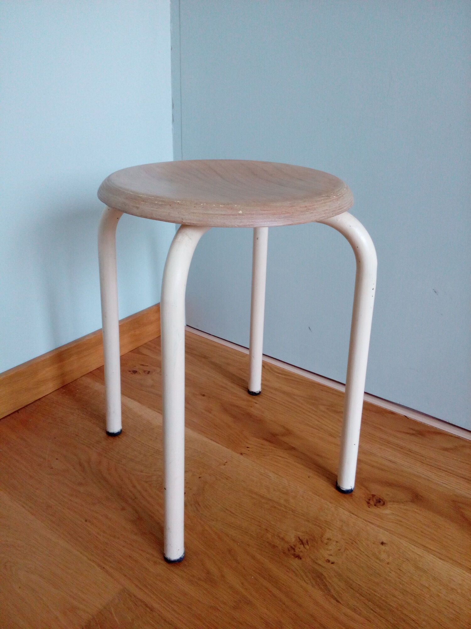 Industrial tubular metal stick sitting round in wood