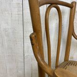 Curved wood and cane armchair