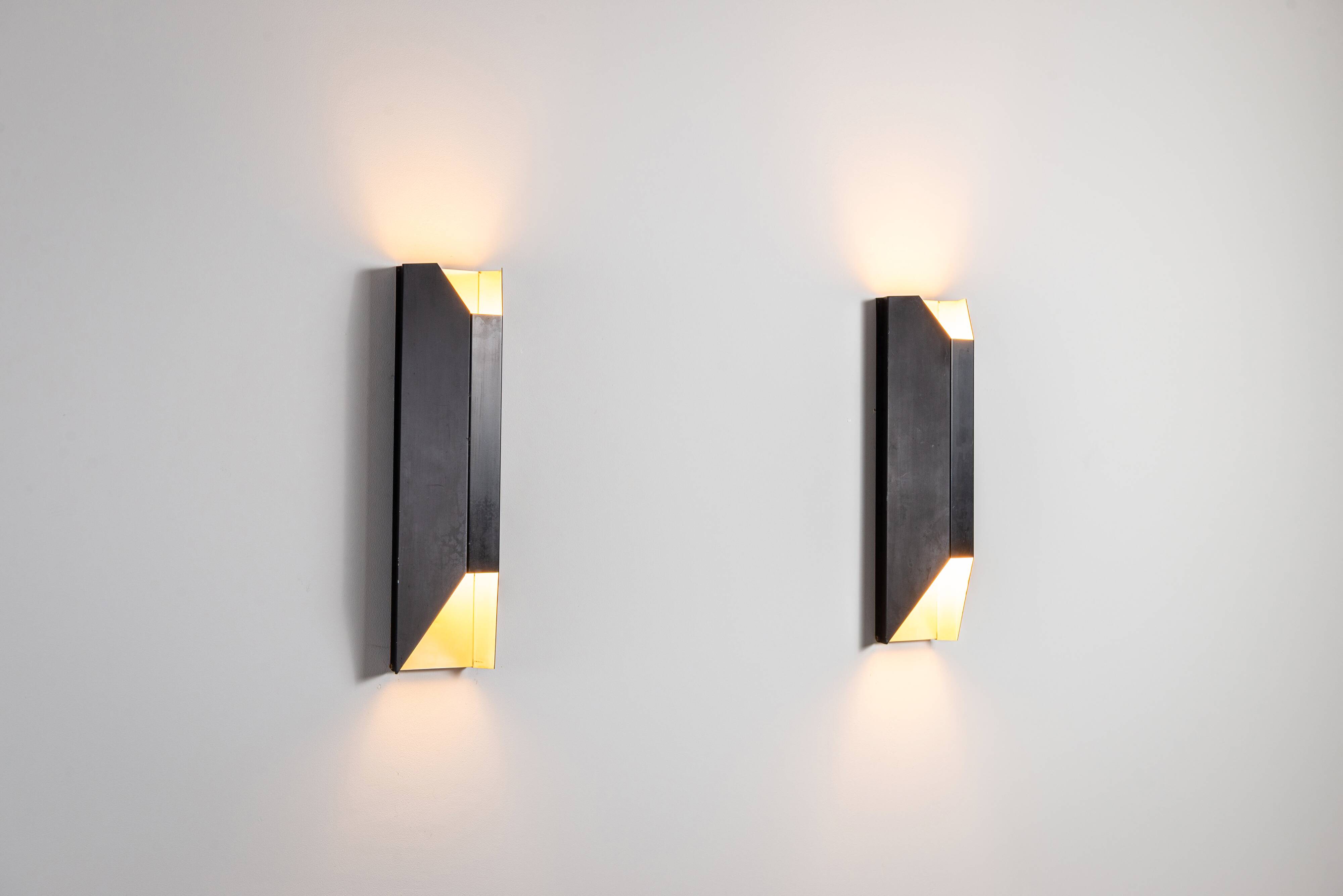 Architectural pair of vintage black metal wall lamps with angular geometric