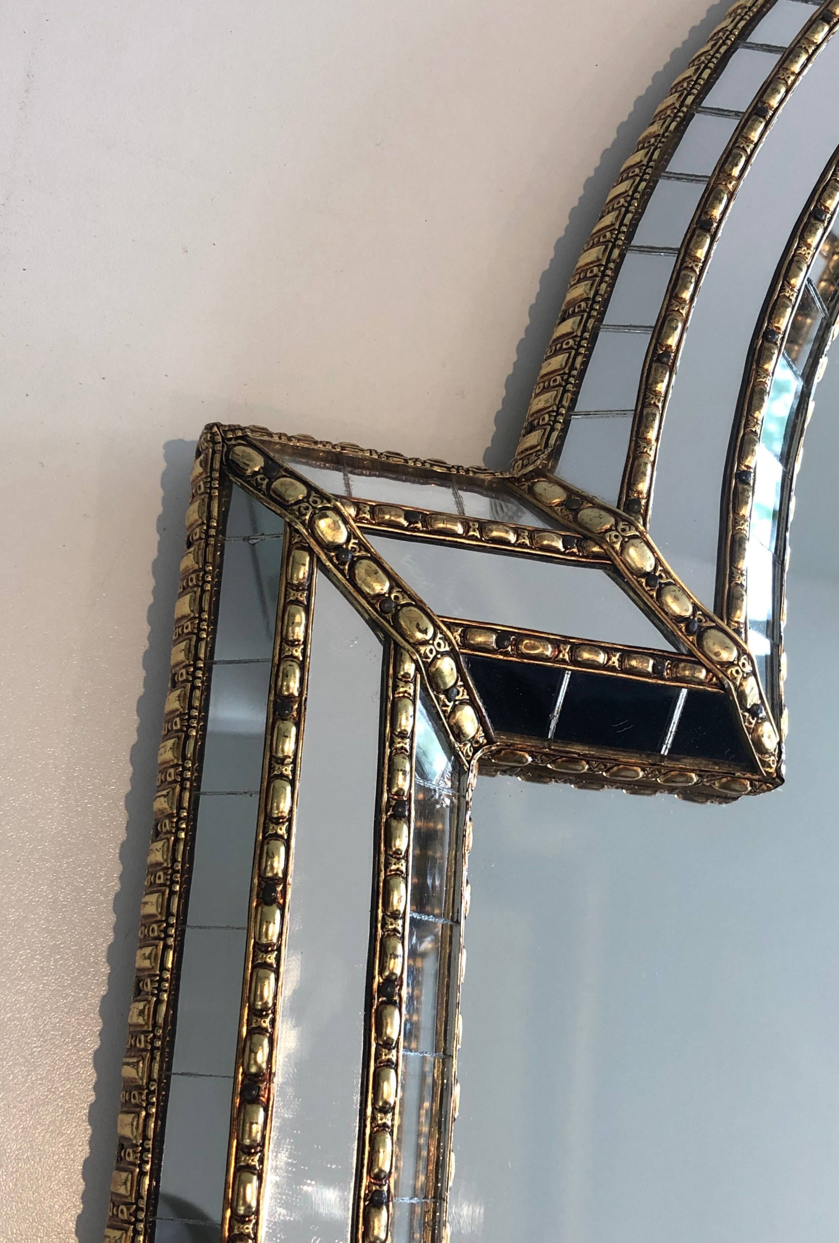 Multi-faceted mirror and brass garlands