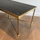Neoclassical brass coffee table with a black leather top and golden borders from Maison Jansen.