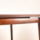 Danish extendable dining table in rosewood and brass by Poul Volther