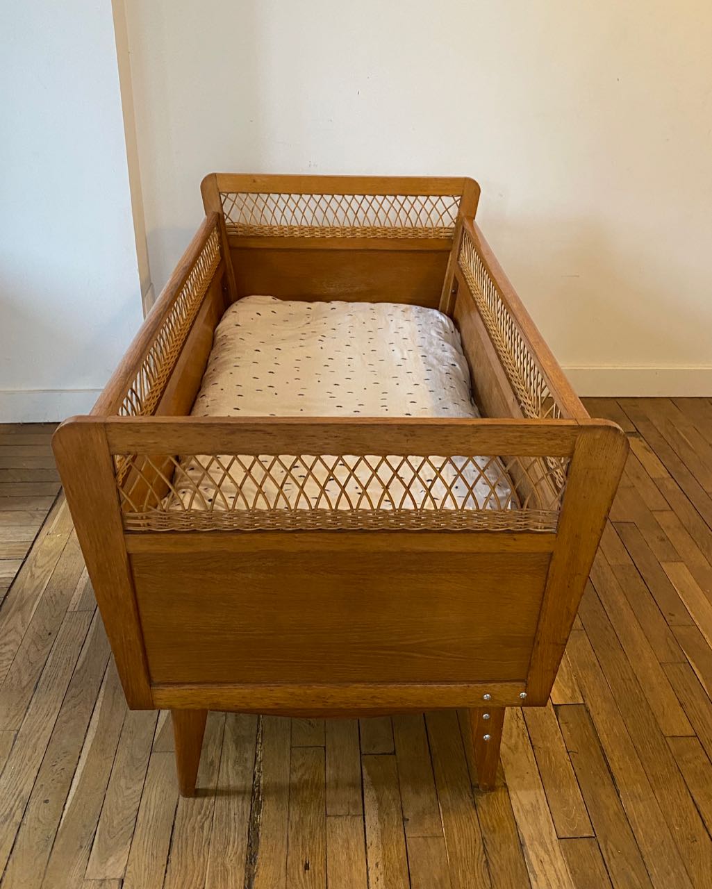 Wooden and wicker baby bed