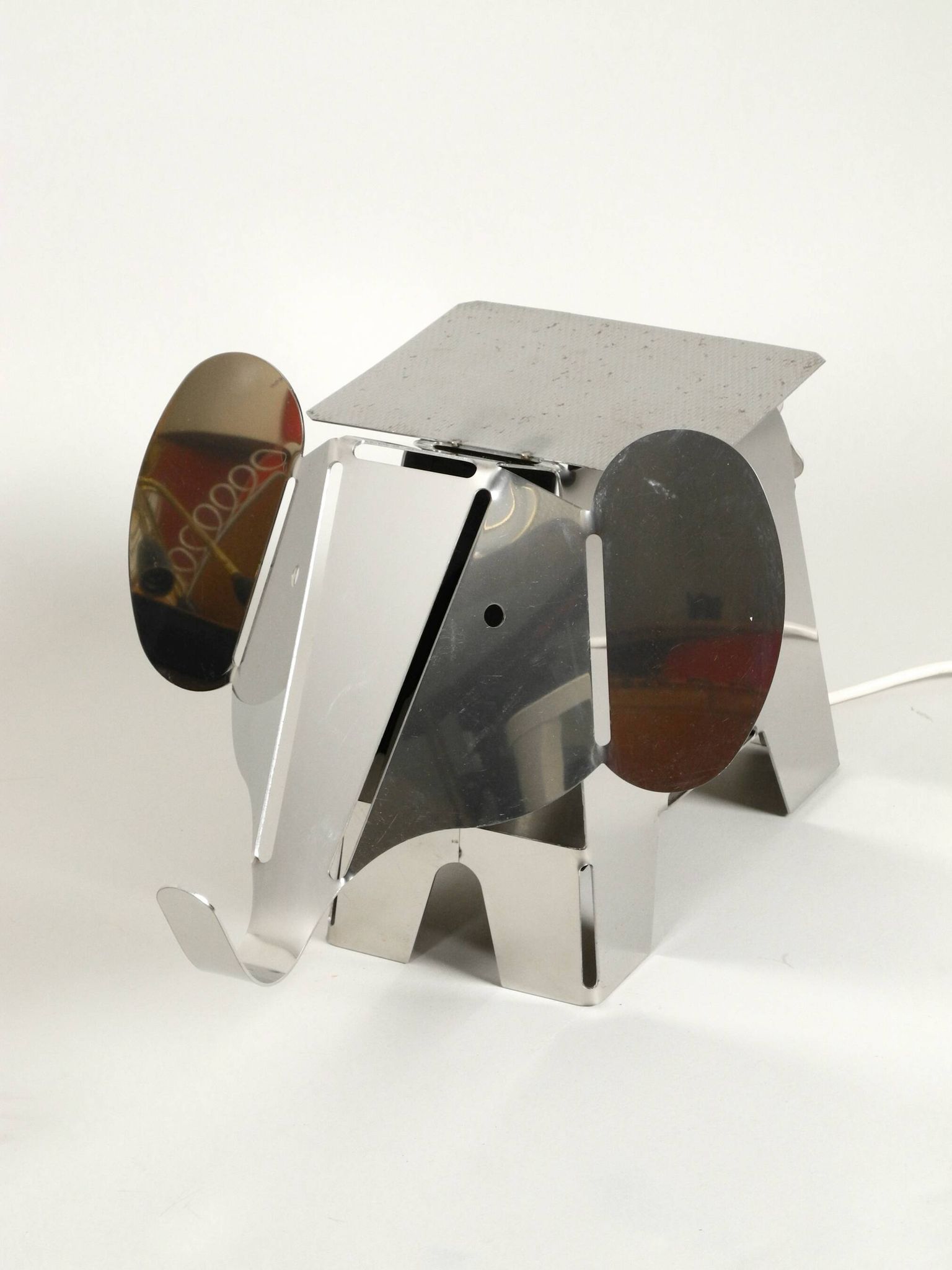 80s heavy metal chrome elephant floor lamp as side table Postmodern design