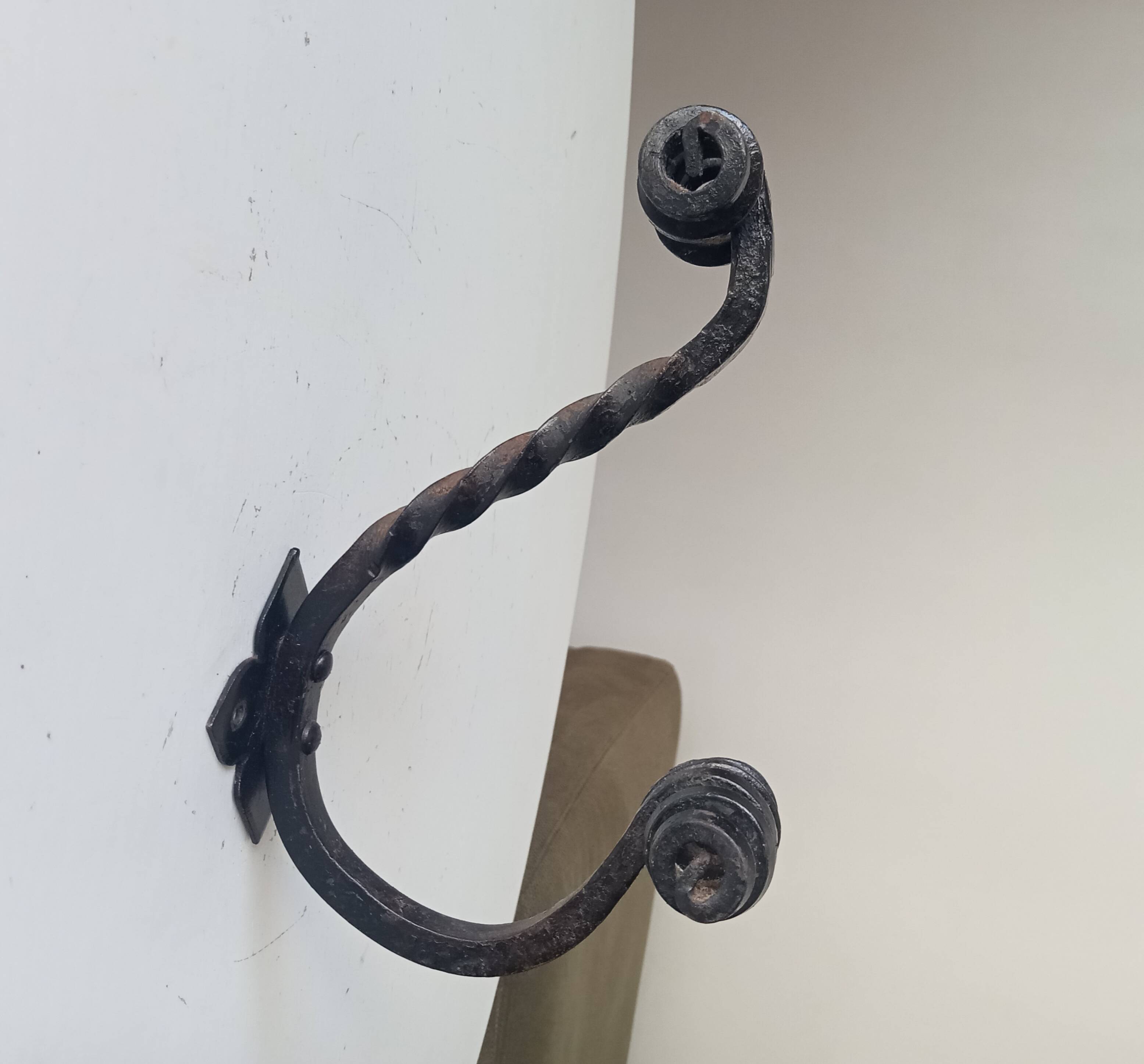 Brutalist wall coat rack in wrought iron.