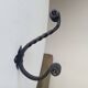 Brutalist wall coat rack in wrought iron.
