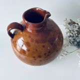 Old pitcher in glazed terracotta
