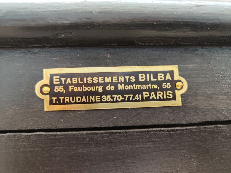 Old wooden window of black patina store two doors