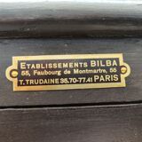 Old wooden window of black patina store two doors