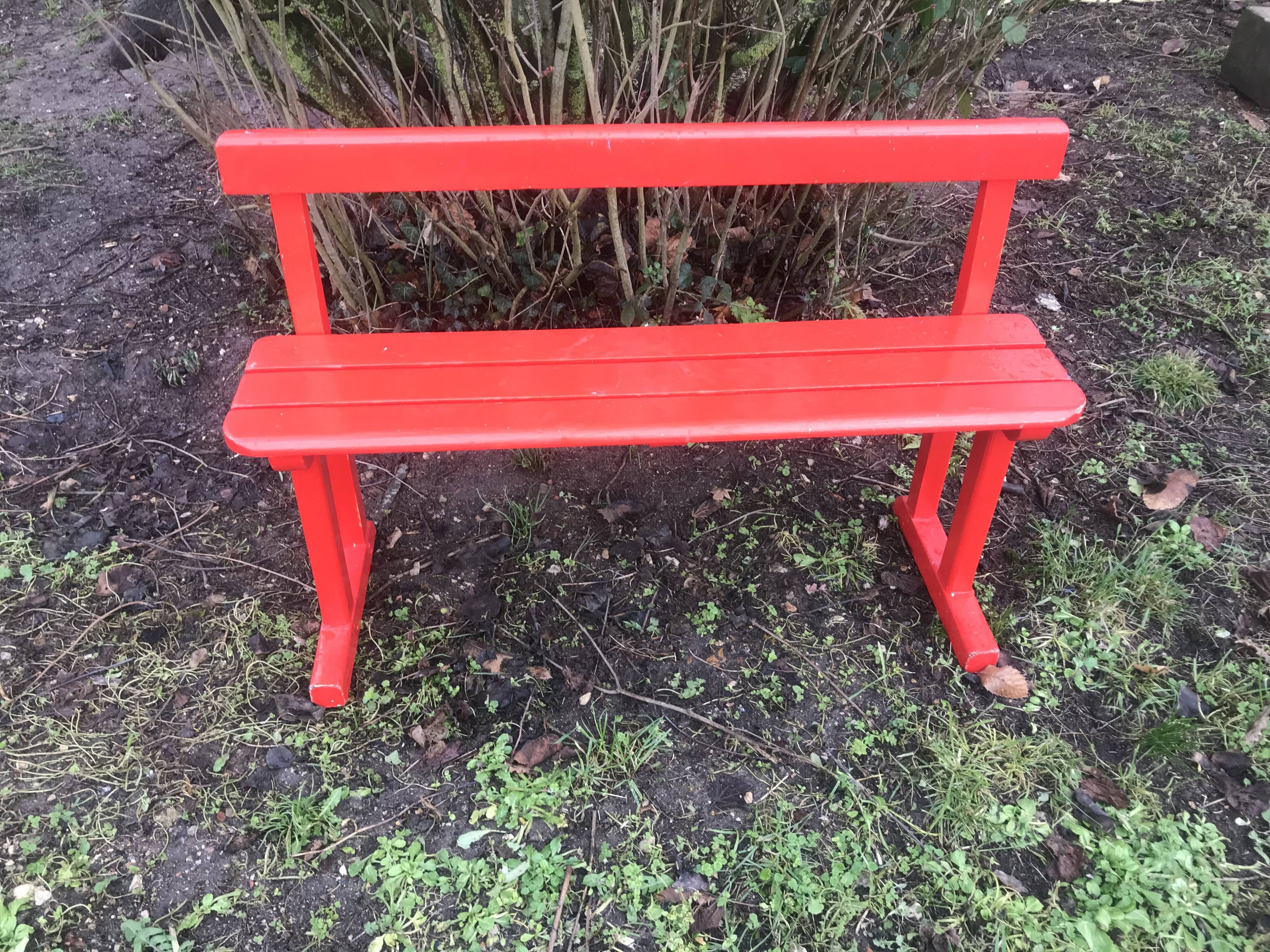 Red old schoolboy bench