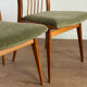 Scandinavian chairs with green velvet upholstery.