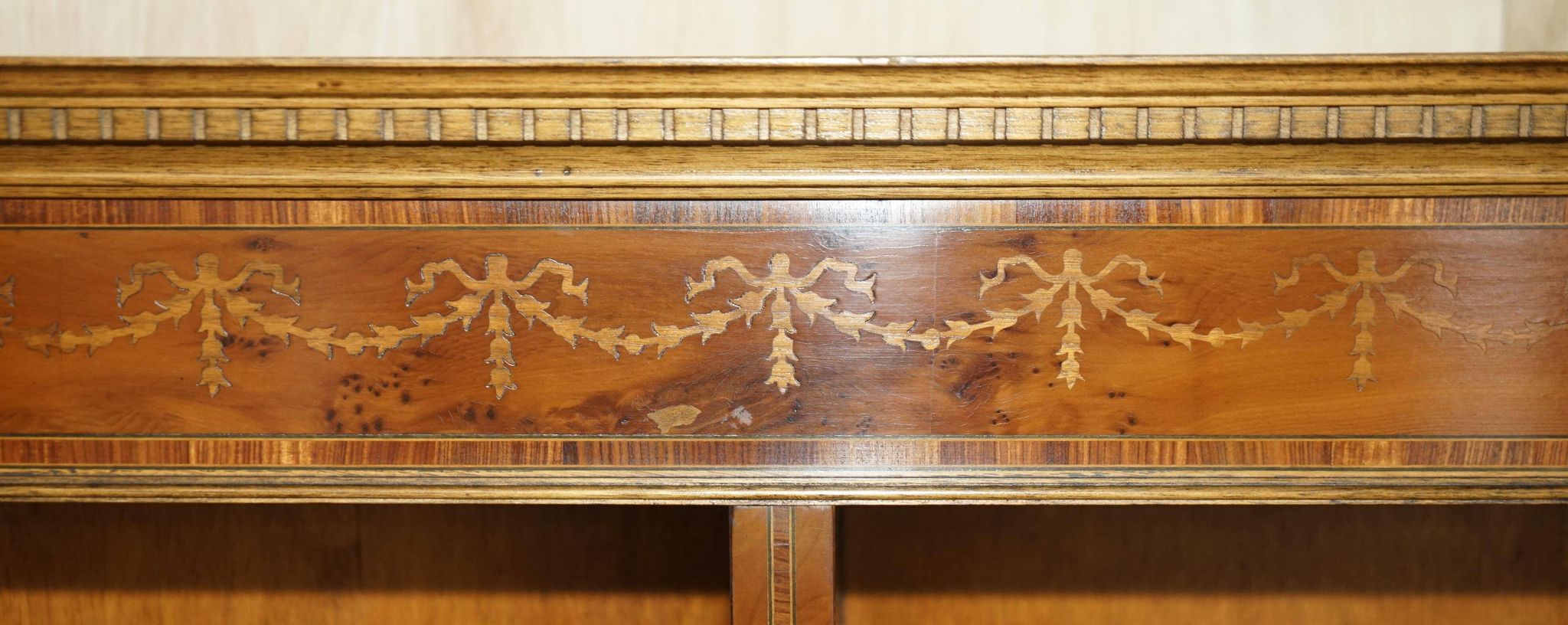 Pair of Sheraton Revival bookcases in satinwood, walnut, and yew.