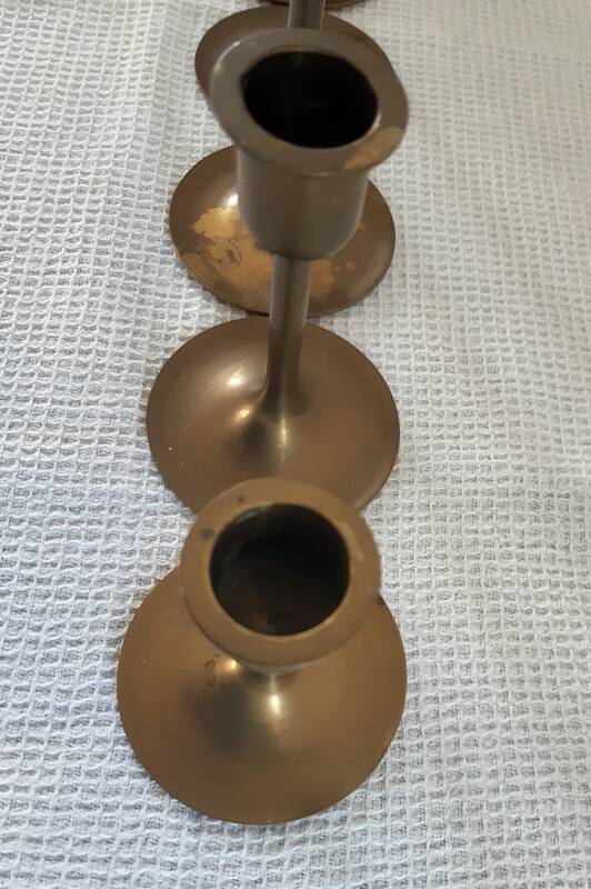 Set of 7 vintage brass candlesticks.