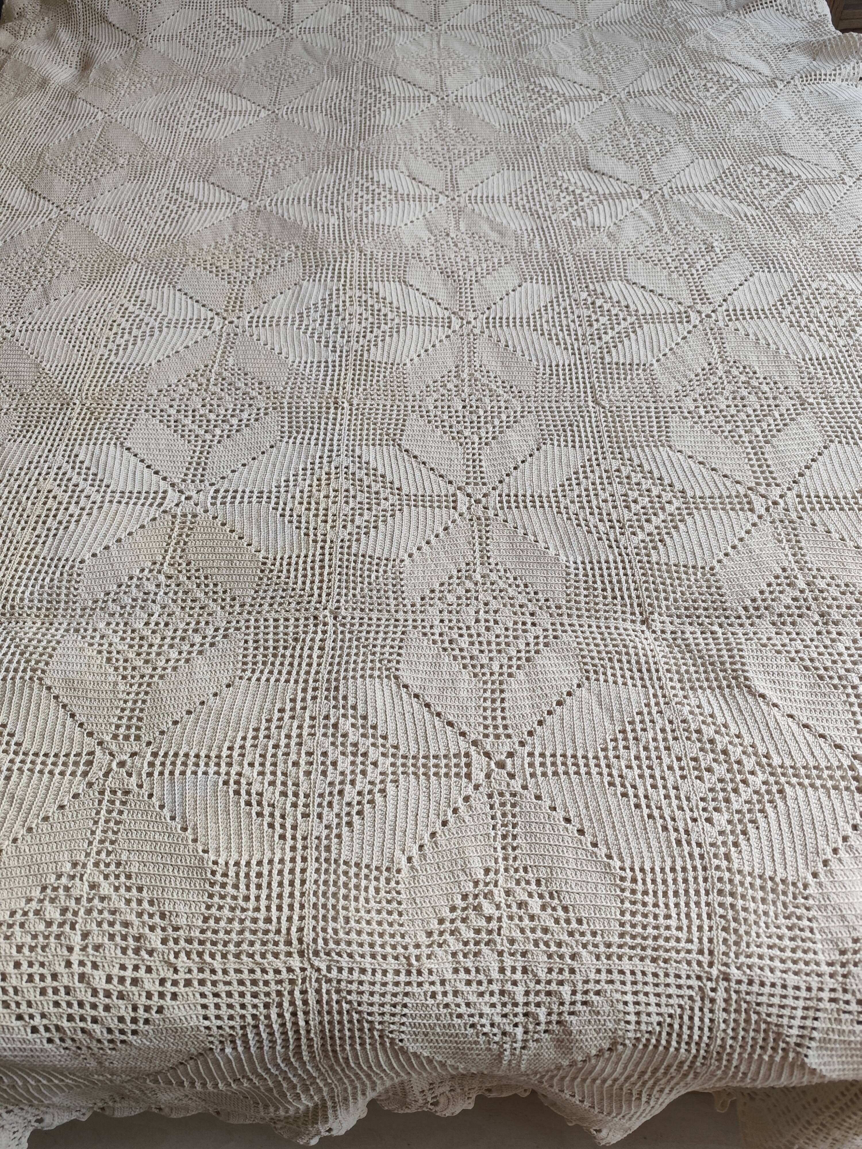 White cotton bedspread, crocheted sofa throw with star patterns