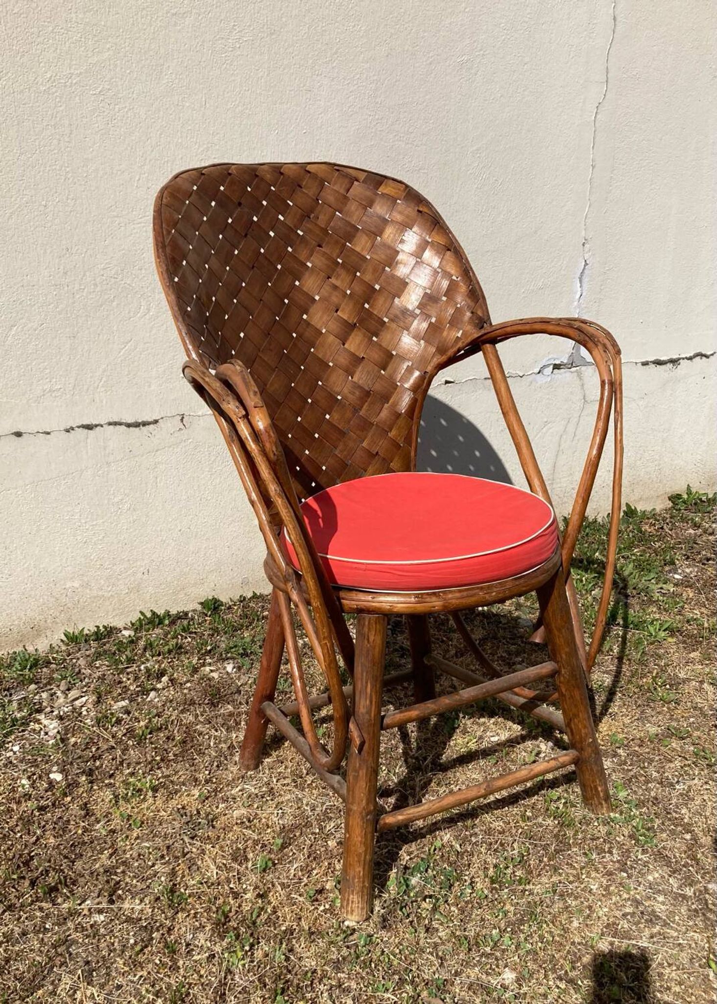 Vintage 1970s armchair in curved woven chestnut + seat cushion